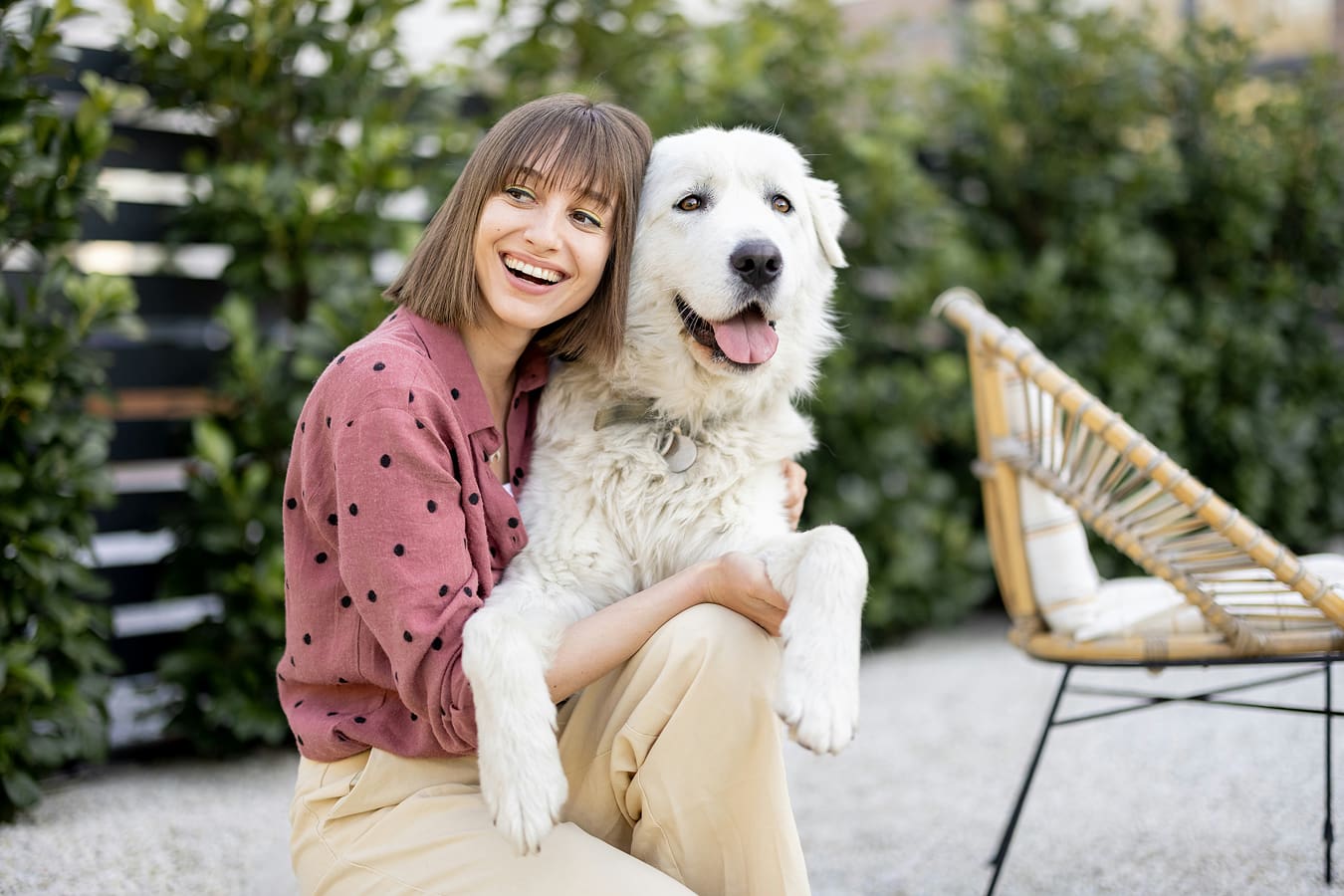 Happy girl sitting with her happy fluppy dog