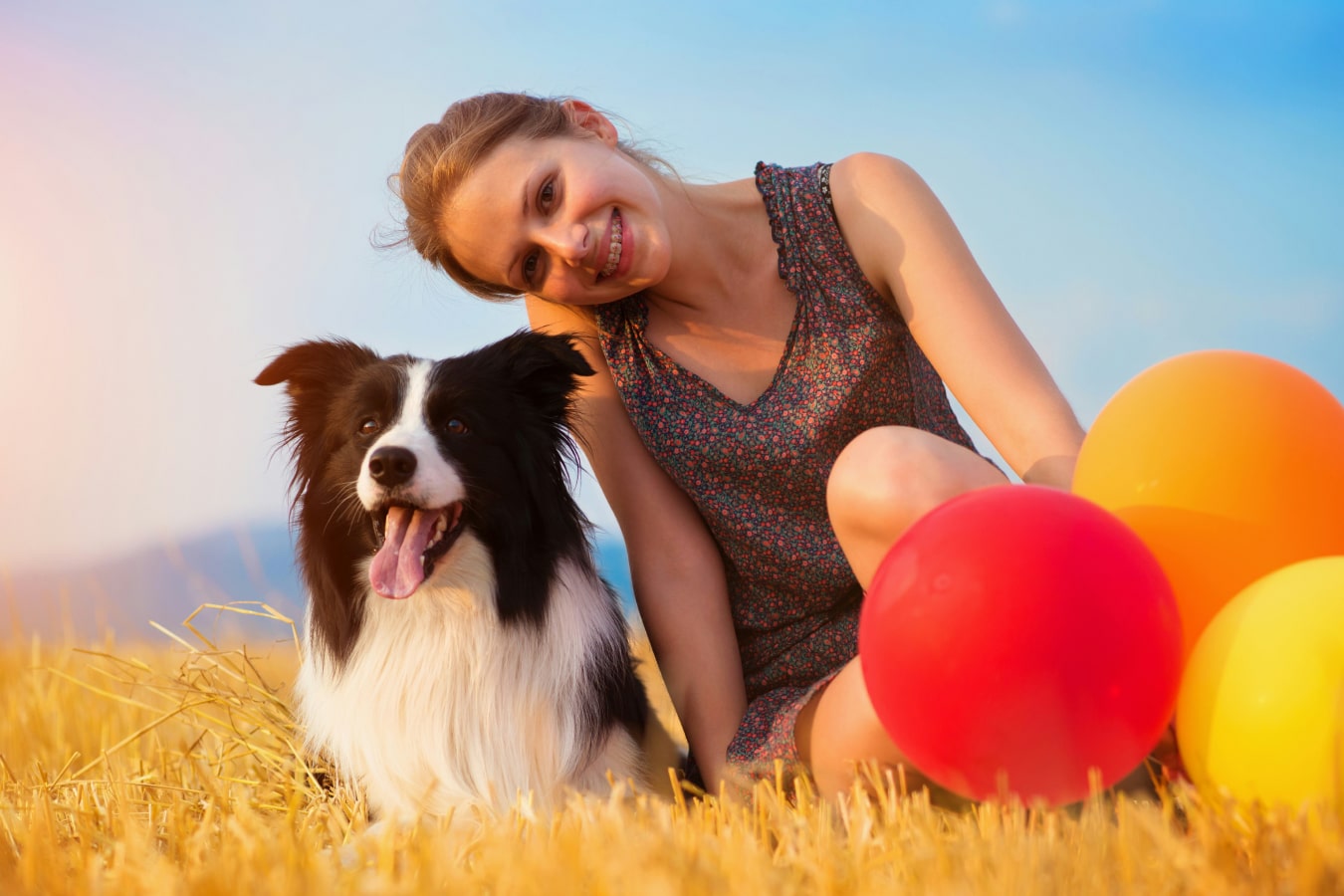 Happy girl with her dog in farm